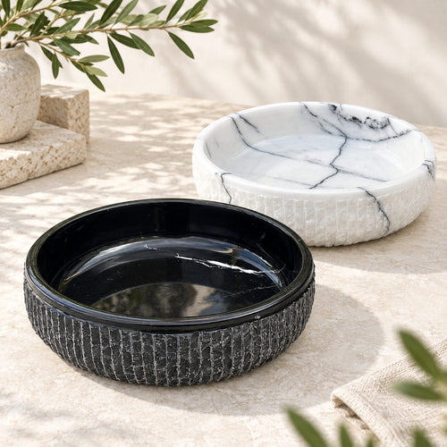 Black marble fruit bowl with hand-chiseled textured exterior and polished interior, 10 inch round, on white background