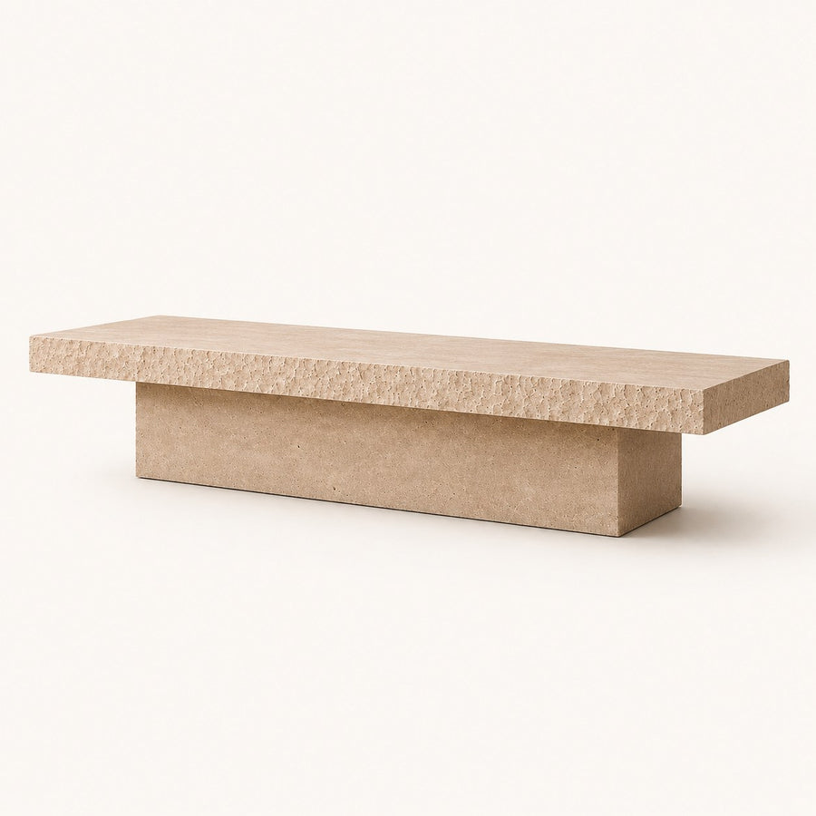 A modern low coffee table with a thick, textured light beige stone top and a matching rectangular concrete base, shown on a clean off-white background.