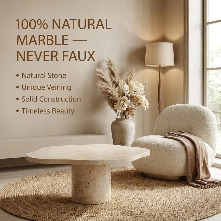 A styled interior scene showing a round natural marble coffee table in a warm, beige-toned room. Text on the left reads '100% NATURAL MARBLE — NEVER FAUX' with bullet points about natural stone, unique veining, solid construction, and timeless beauty.
