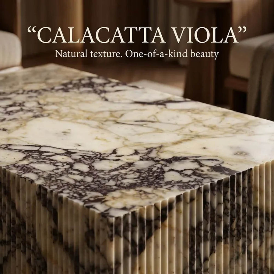 Calacatta Viola marble slab with natural veining, shown as a stacked block of multiple slabs. Text overlay at the top reads: 'CALACATTA VIOLA' and 'Natural texture.