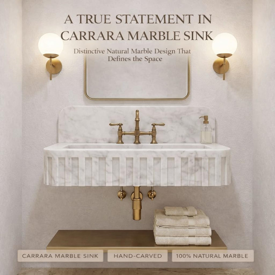 White Carrara marble vanity sink with soft gray veining and matching marble backsplash