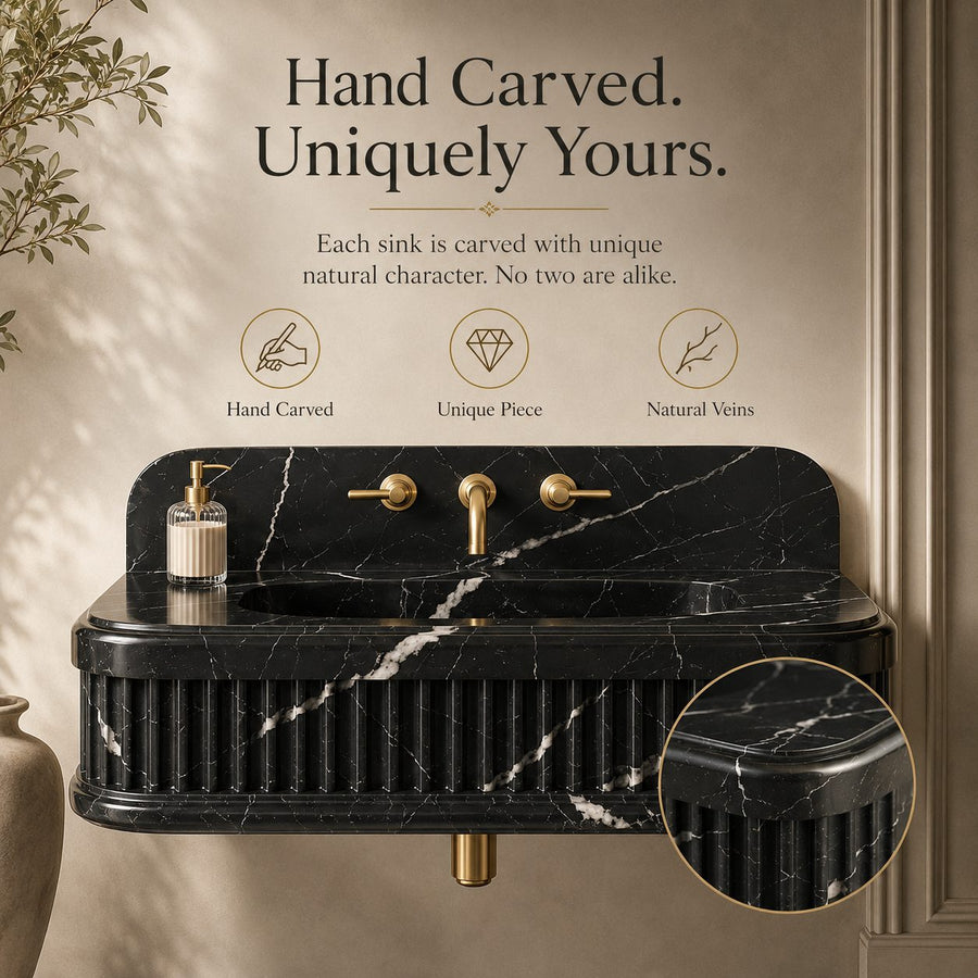 A wall-mounted black marble sink with gold faucet hardware, shown in a styled bathroom setting with decorative text and icons highlighting hand-carved details. A circular inset shows a close-up of the marble texture.