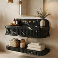 Bathroom vanity with black marble countertop, gold fixtures, and decorative elements.