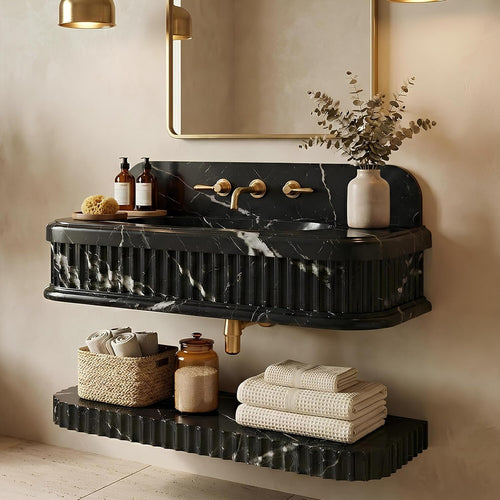 Bathroom vanity with black marble countertop, gold fixtures, and decorative elements.