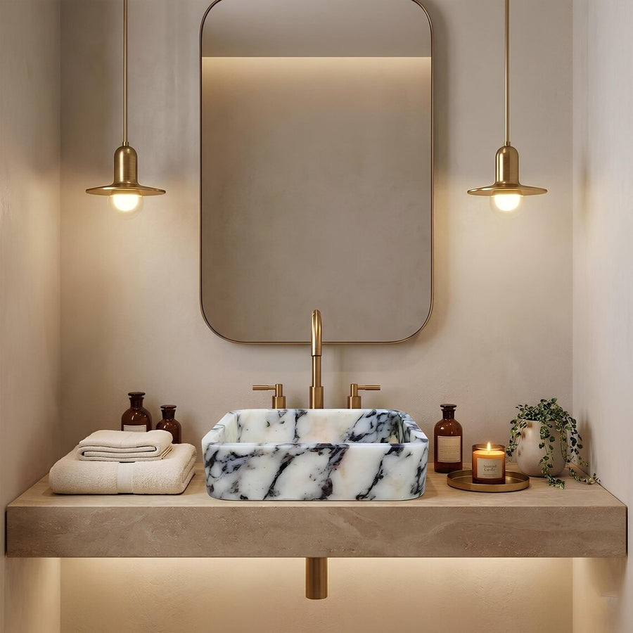 Black and white marble sink on a wood floating shelf in an olive green bathroom with black fixtures