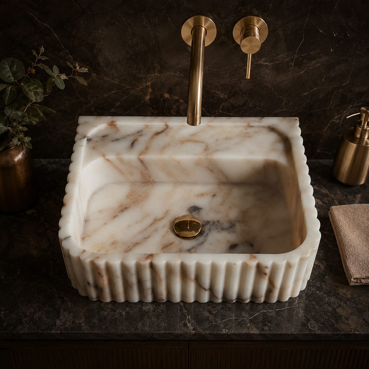 Top view of Calacatta Gold marble sink with scalloped fluted edge and brass faucet