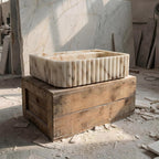 Marble planter on a wooden crate in a construction site setting