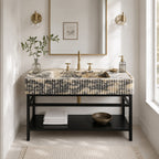 A modern bathroom vanity with a black metal frame and a marble-look top featuring a pleated front panel. The sink has a matte brass faucet and two separate hot/cold handles.