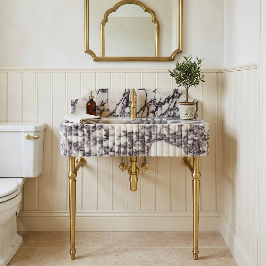 Calacatta Viola marble sink in cream wainscoting bathroom
