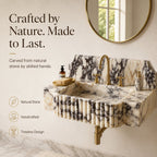 A wall-mounted marble sink with a fluted front, gold faucet, and matching gold soap dispenser, shown in a bathroom setting with text callouts and a round mirror on the wall.