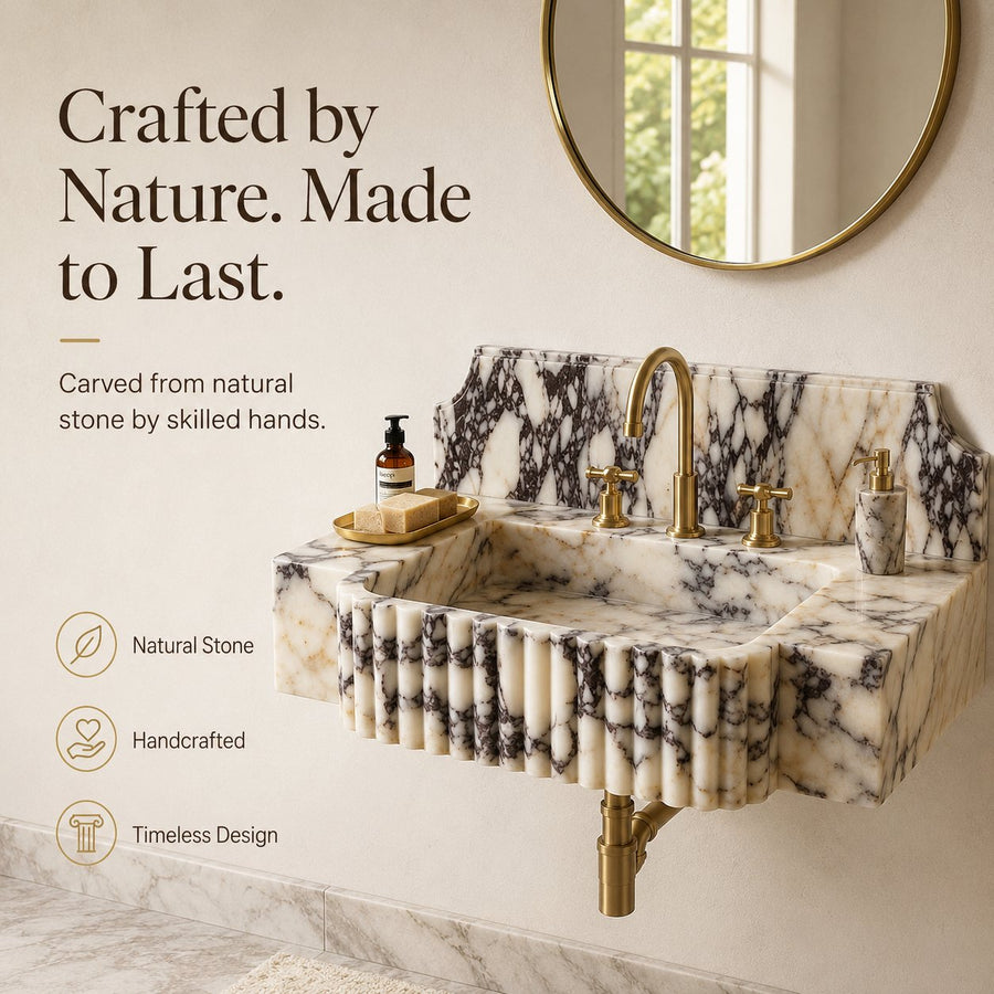 A wall-mounted marble sink with a fluted front, gold faucet, and matching gold soap dispenser, shown in a bathroom setting with text callouts and a round mirror on the wall.