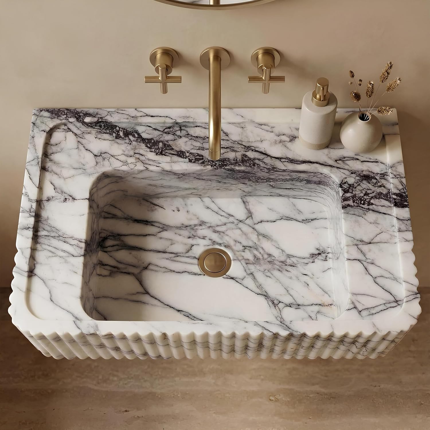 Marble-patterned sink with calacatta viola fixtures on a beige wall.