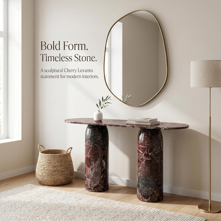 Marble console table with oval mirror and decorative items in a room setting.