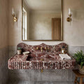 Bathroom with a marble sink and gold fixtures