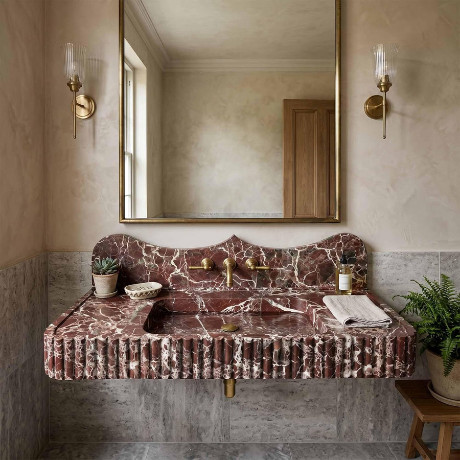 Bathroom with a marble sink and gold fixtures