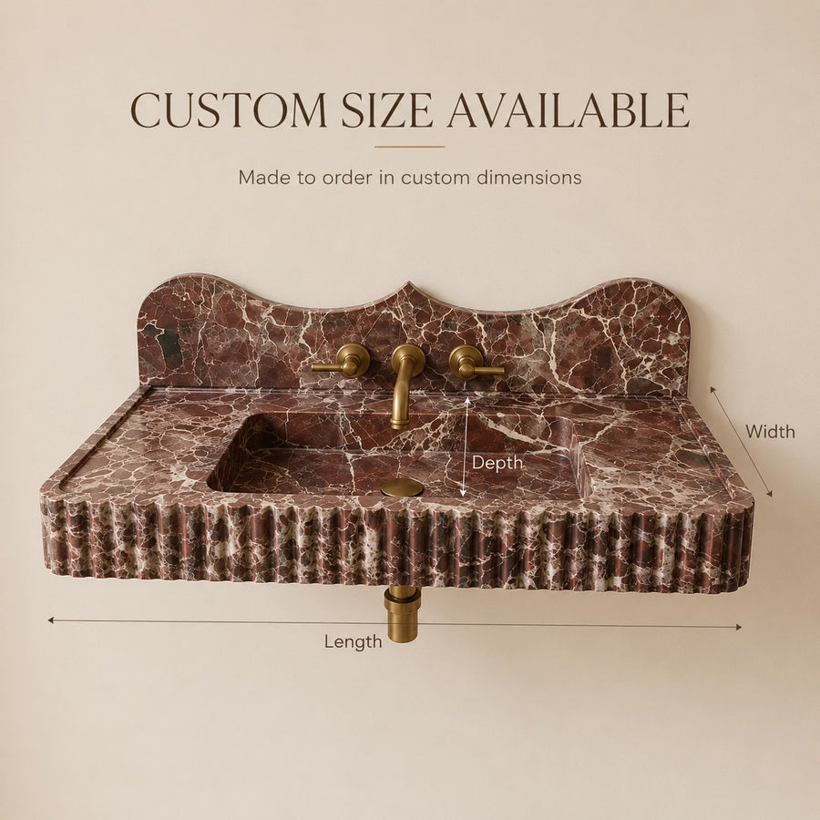 A freestanding rectangular bathroom sink with a scalloped backplate in dark reddish-brown marble with white veining, shown with dimension labels for length, width, and depth, plus text stating custom size available.