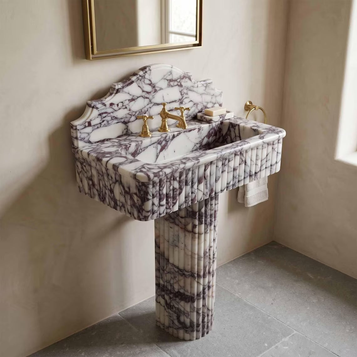 Calacatta viola marble sink with pedestal in a bathroom