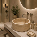 Bathroom with a stone sink, faucet, and toiletries.