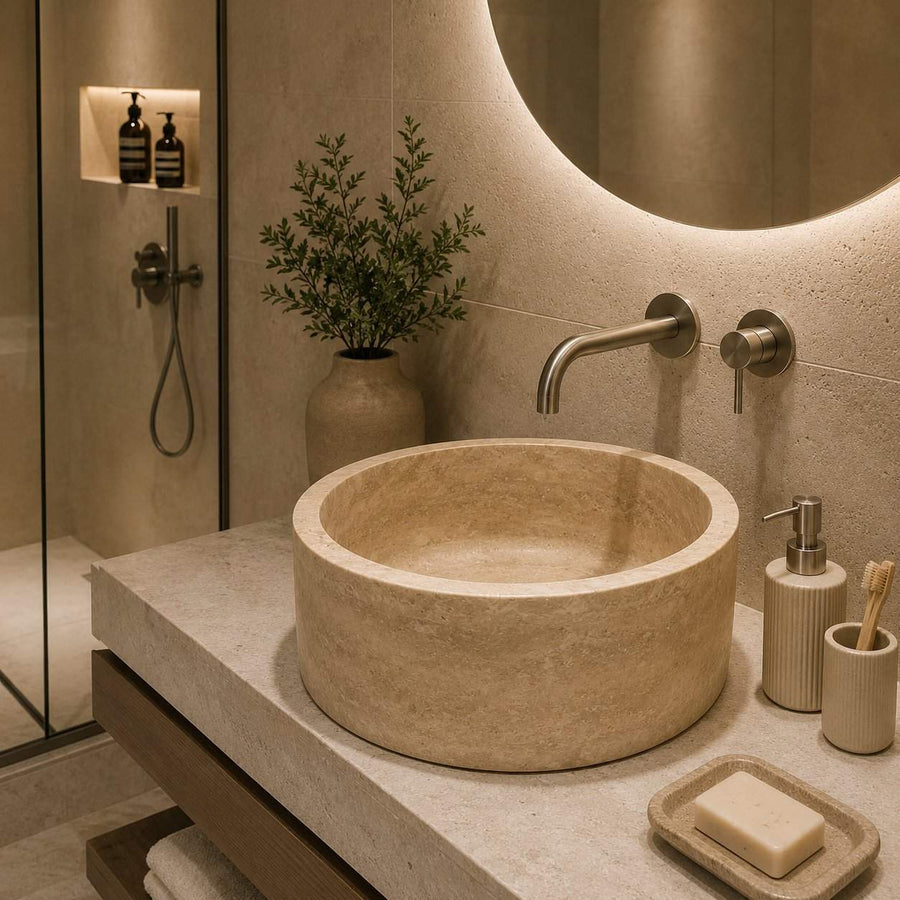 Bathroom with a stone sink, faucet, and toiletries.