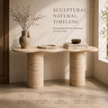 Handcrafted Roman Travertine console table with decorative items in a room setting.