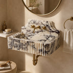 Fluted marble sink wall mounted in warm neutral bathroom