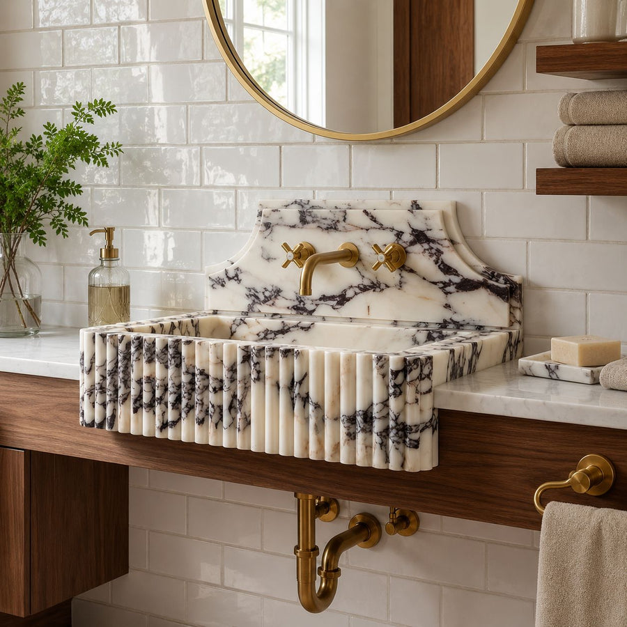 Fluted marble sink with backsplash in subway tile bathroom