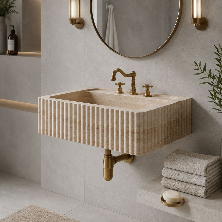 hand carved custom travertine sink in a modern bathroom