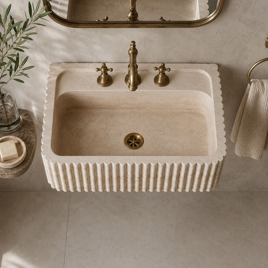top view of hand carved custom travertine sink in a modern bathroom