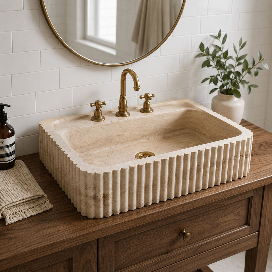 hand carved custom travertine sink in a modern bathroom