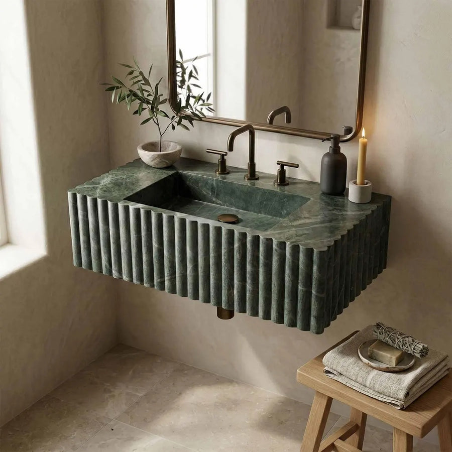 Modern bathroom with a green marble sink and decorative elements.
