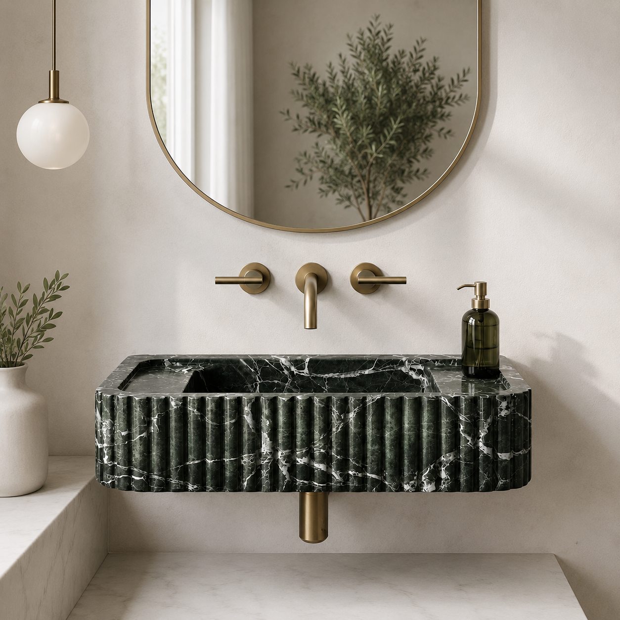 Green Levanto marble fluted sink in a dark moody bathroom with brass fixtures