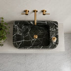 Top view of Green Levanto marble sink with white veining on white countertop
