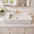 Bathroom with a modern marble sink and mirror on a wall.