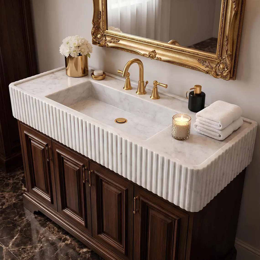 Bathroom with a modern marble sink and mirror on a wall.