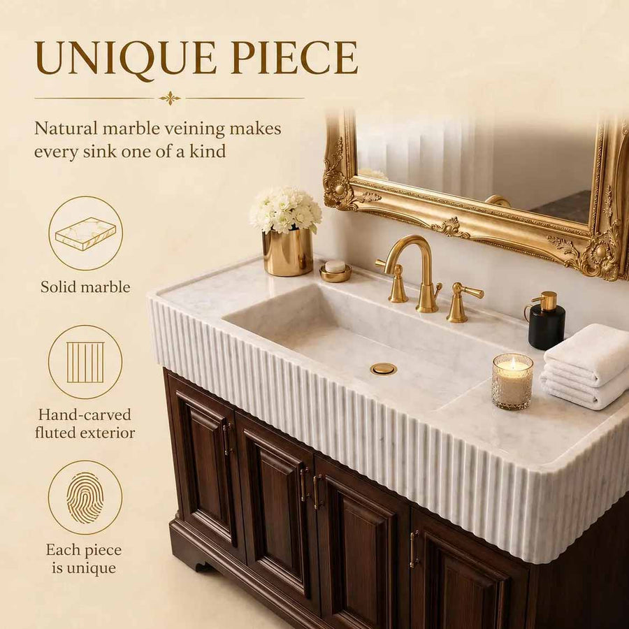 Bathroom with a modern marble sink and mirror on a wall.