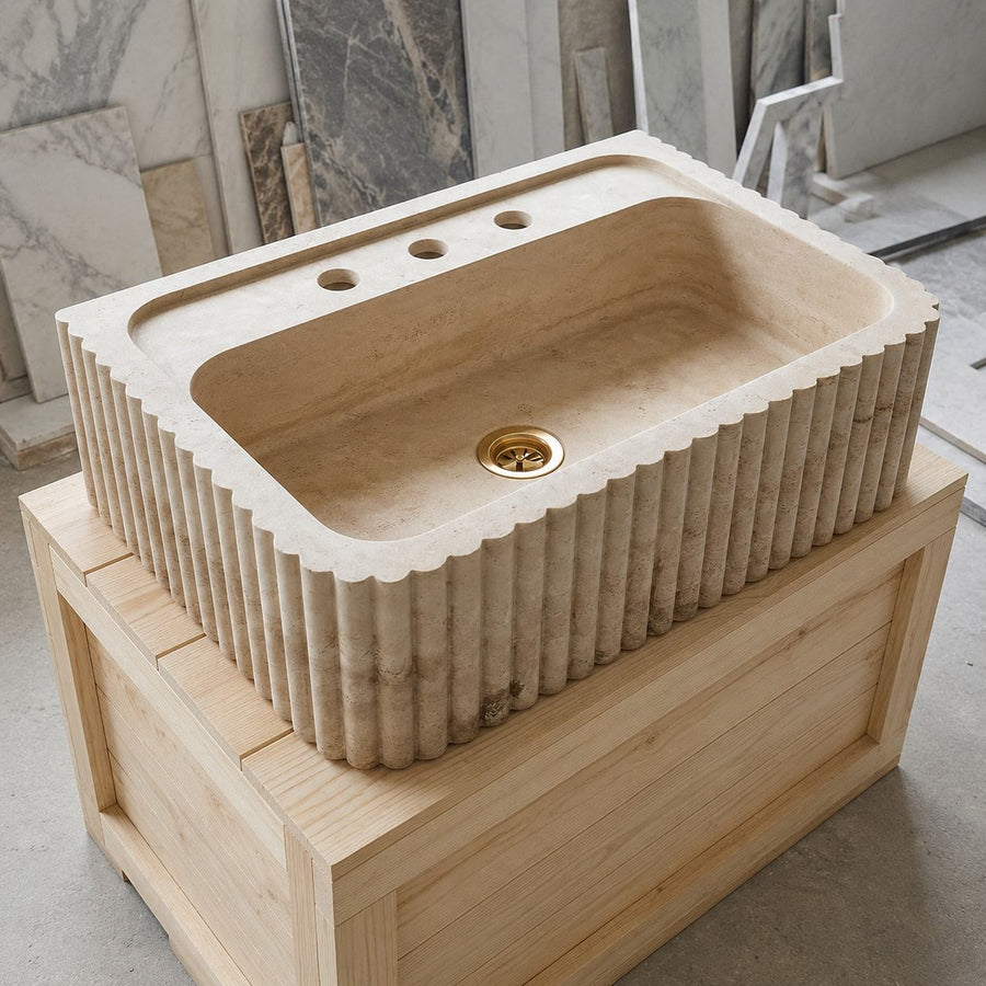 hand carved custom travertine sink in a stone workshop
