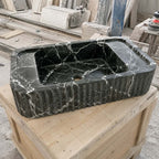 Handcrafted green Levanto marble sink shown in a stone workshop