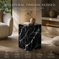 Black marble side table in a modern living room setting with text describing its qualities.