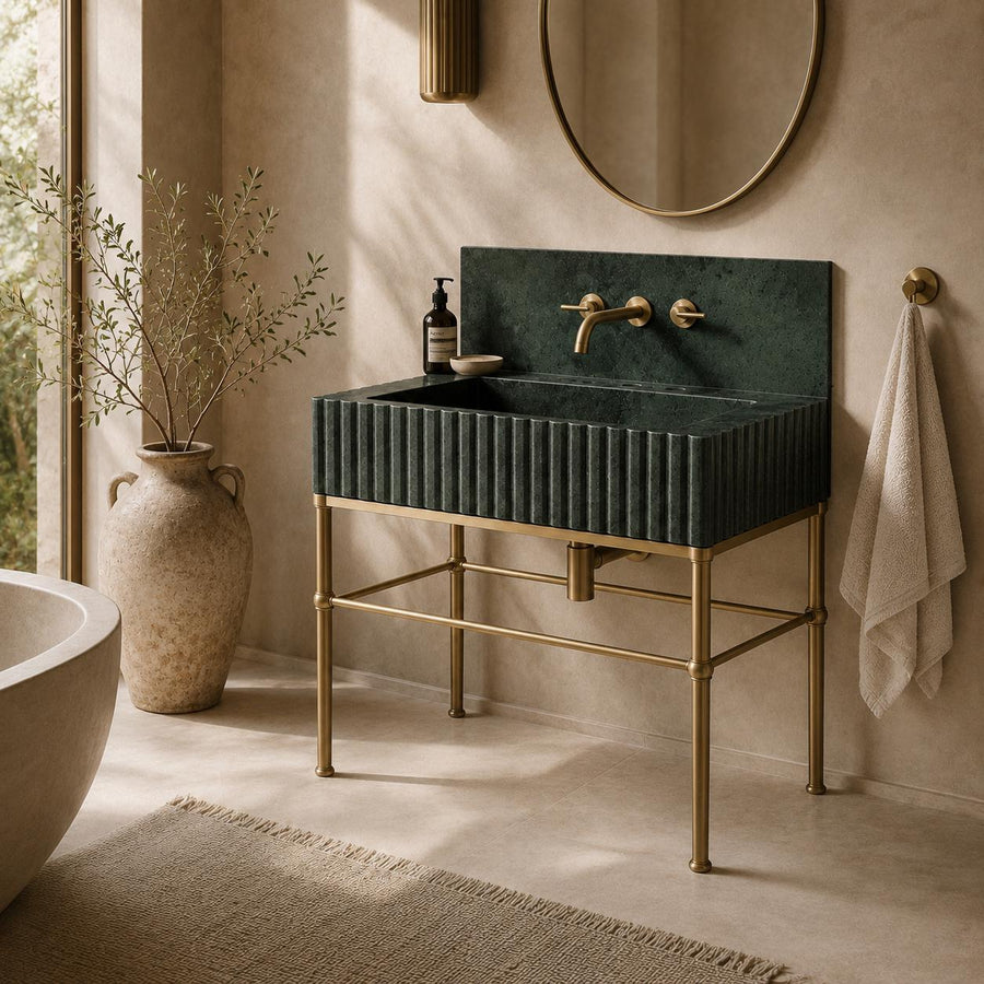 Dark green fluted marble basin on a gold-toned brass stand with matching backsplash