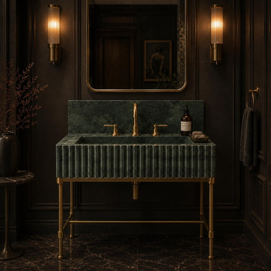 Green marble bathroom vanity with fluted front, brass frame and mirror above