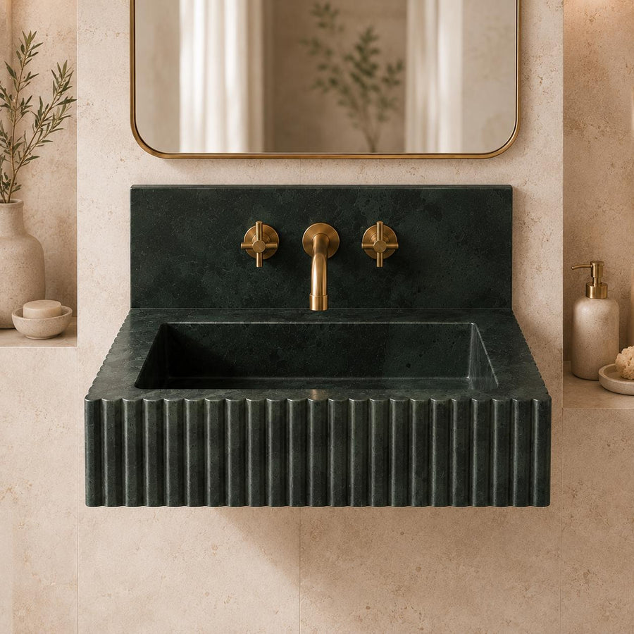 Dark green marble wall-hung fluted sink with brass cross-handle valves