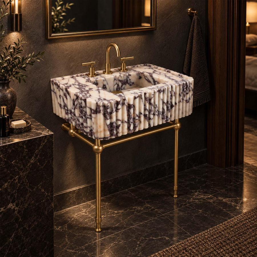 Calacatta Viola wall-mounted fluted sink supported by a brass frame with brass faucet and side handles