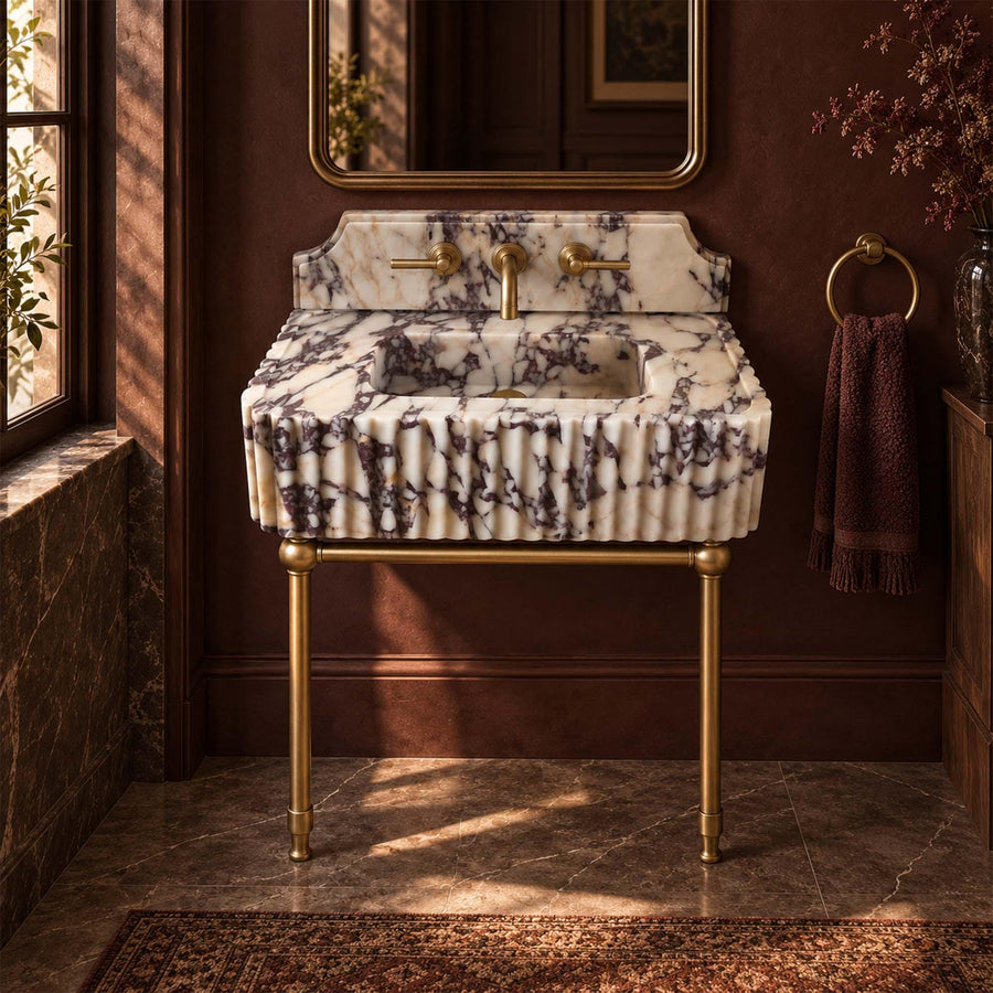 Floating Calacatta Viola marble vanity sink with fluted front, brass legs and brass faucet