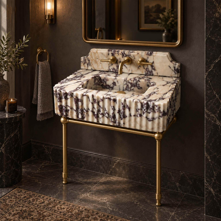 Calacatta Viola marble console sink with matching backsplash and brushed brass legs in a luxury bathroom