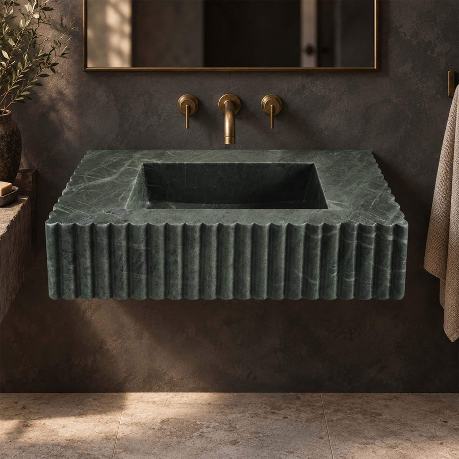 Green marble floating vanity sink with scalloped edge in a warm modern bathroom