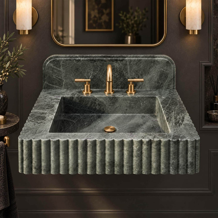 Deep rectangular basin of a green marble fluted sink with integrated backsplash