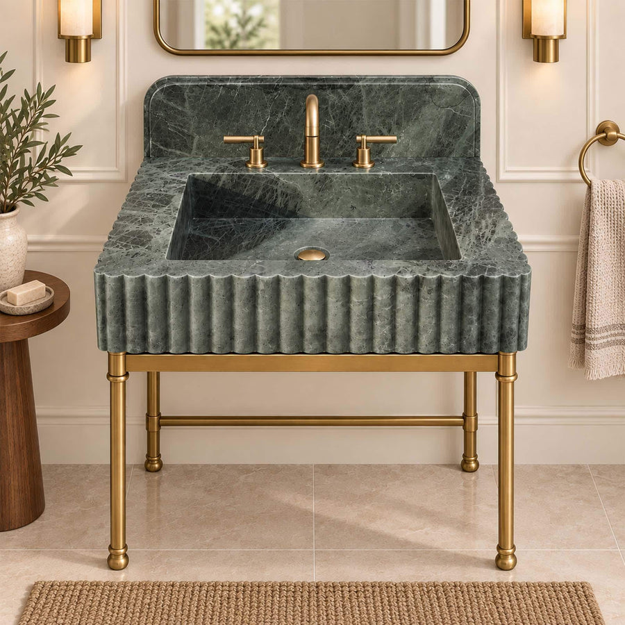 Green marble sink with three-hole widespread faucet set on the marble deck