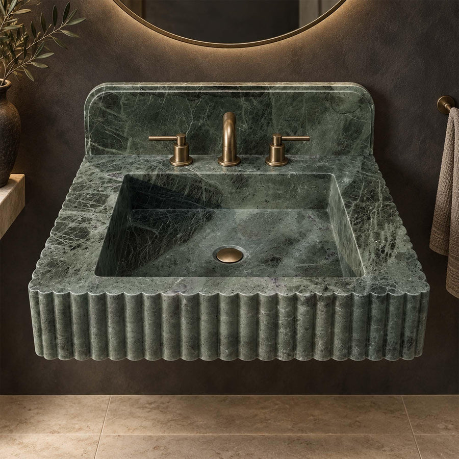 Green marble console vanity sink with rounded backsplash and brass fixtures