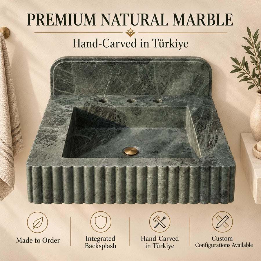Green marble wall-mounted sink with rounded backsplash in a luxury powder room