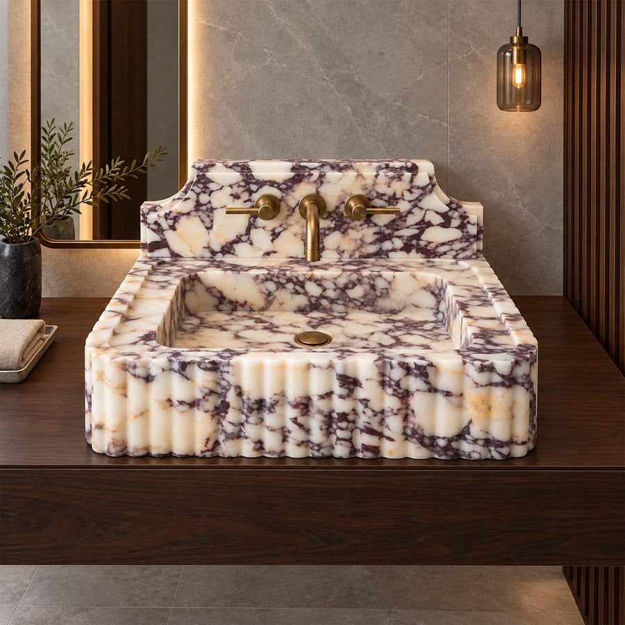 Natural stone fluted console sink in Calacatta Viola with brass fittings
